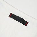 Toby Black leather brand label with red stitching on white bag interior
