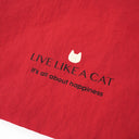 "Close-up of WHY NOT? Toby Bag back showing 'Live Like A Cat - It's all about happiness' text with cat icon"