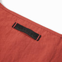 Close-up of Toby Black leather brand label stitched on red nylon interior