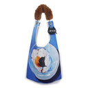 Blue bag with a cat key chain and fur-lined strap on a white background