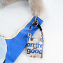 Toby tote Keychain with text 'I'm on the good side' attached to a blue bag front view