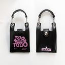 Front and back of leather pouches with 'Too Much Toto' and 'Toby Black' branding on a white background.