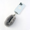 Phone case with a fluffy keychain strap on a white background