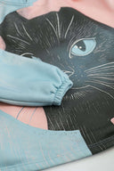 Detailed view of black cat face graphic print with blue eyes and elasticated cuff on Toby Black hoodie