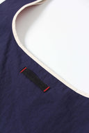 Toby Black leather brand label with red stitching on navy blue bag interior