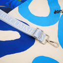 Blue strap with silver buckle on a colorful background