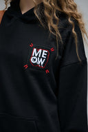 MEOW embroidery detail on black hoodie chest