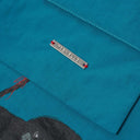 Silver Toby Black metal label with red thread on teal bag interior pocket