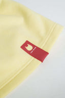 Close-up of red Toby Black cat logo tag detail