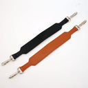 Black and brown leather straps with silver hardware on a white background