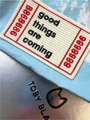 Close-up of 'good things are coming' patch on Toby Bag.