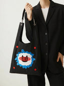 Model holding Meow Energy Toby Bag with 'Live Like A Cat' design.